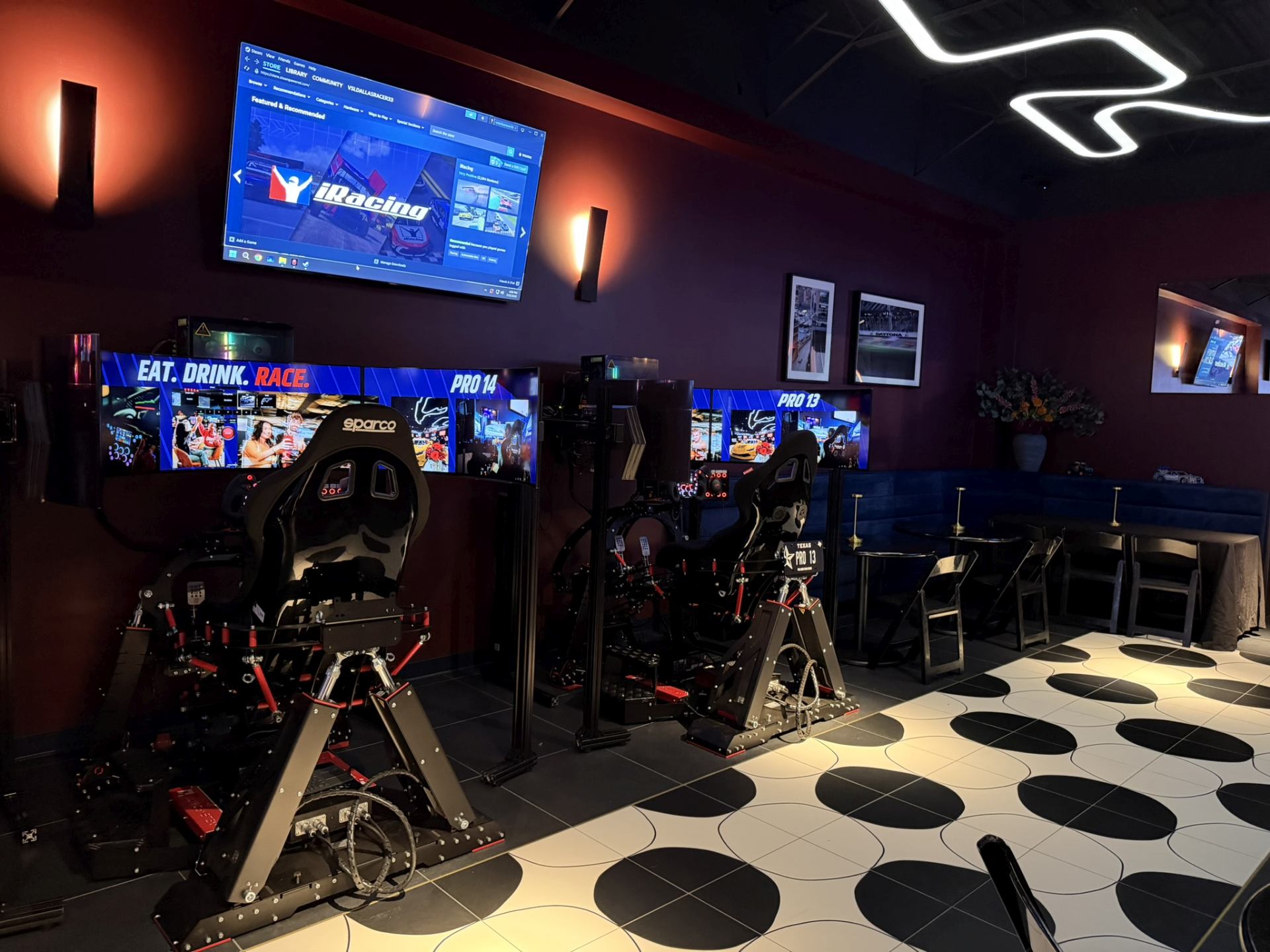 Two Qubic System motion rigs at Velocity Dallas, the Pro 14 and Pro 13 stations, with curved triple screens
