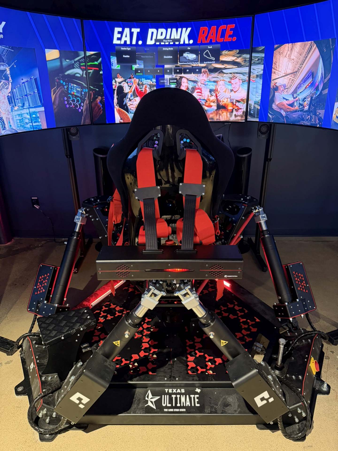 Velocity sim racing lounge in North Dallas, bar seating and a race-track-shaped ceiling light