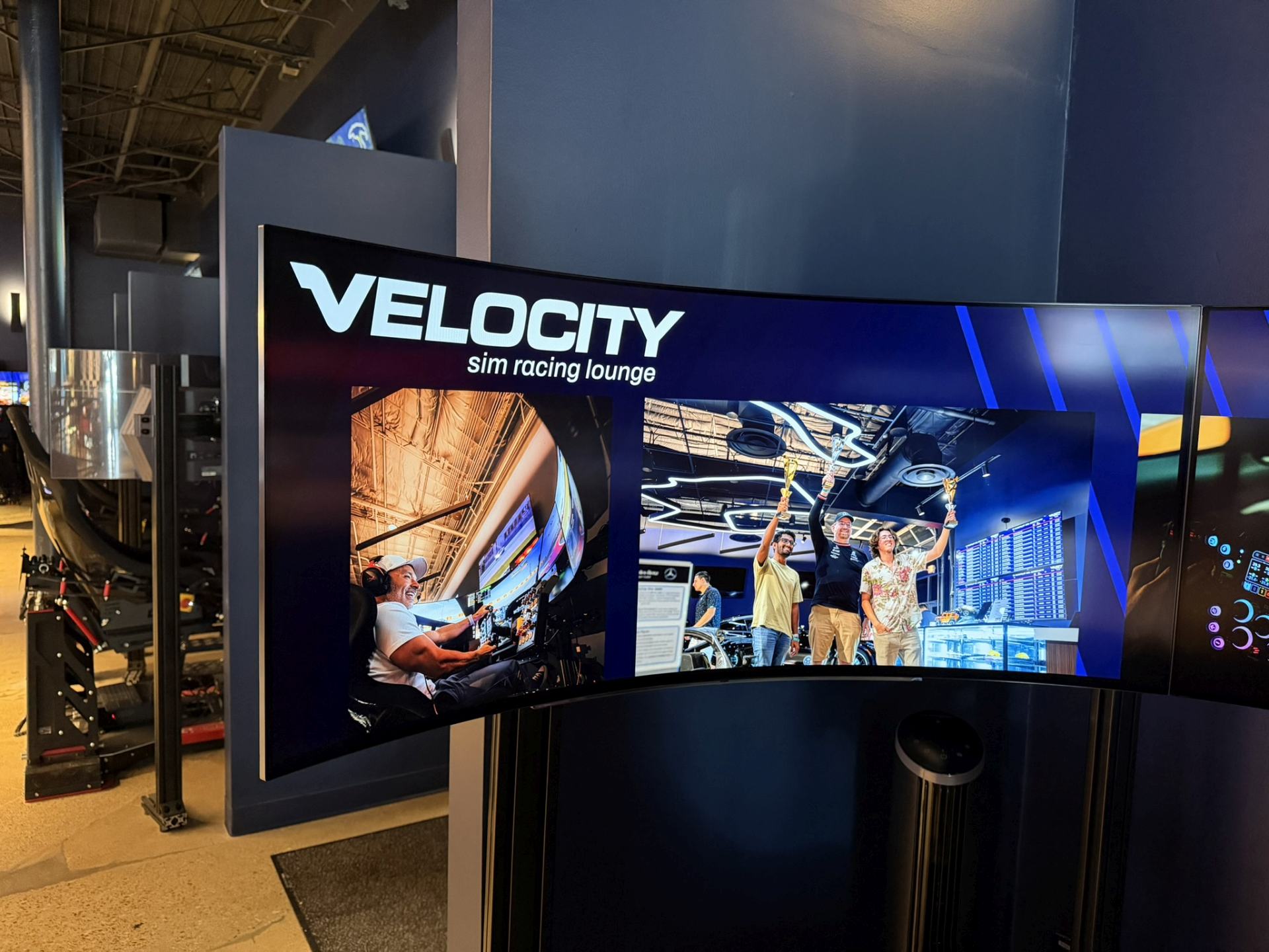 The Velocity Dallas race floor with motion simulators lined up along the wall