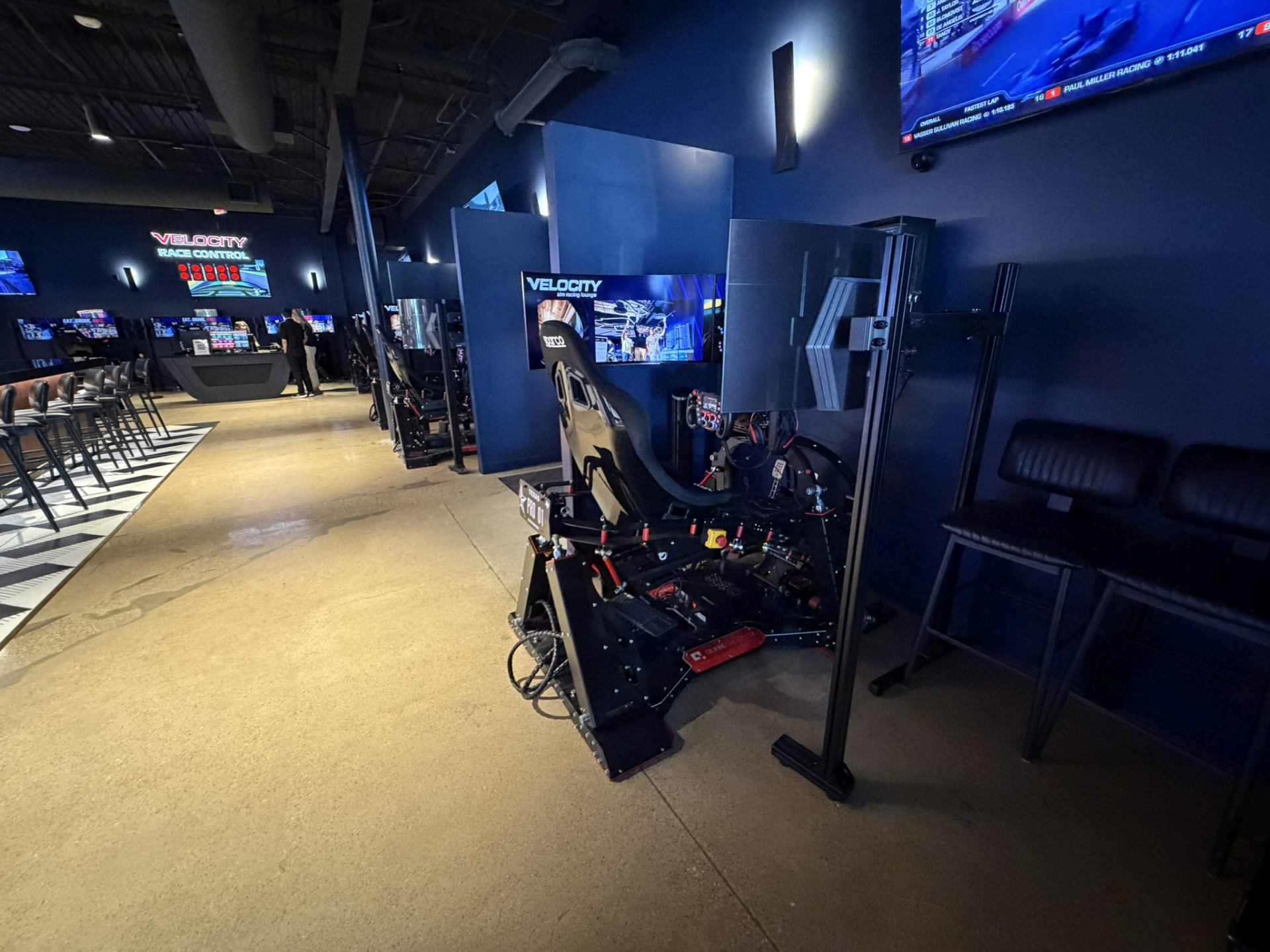 Line of Velocity Dallas sim racing stations seen from the far end of the room